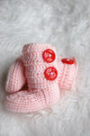 Handmade pink booties with red buttons